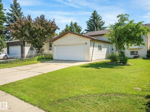 Attached single-car garage with a white overhead door - 2035 49A Street, Edmonton, AB 