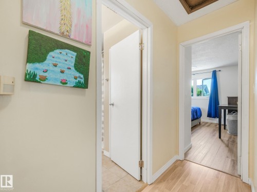Hallway with light-toned walls and wood-finish flooring - 2035 49A Street, Edmonton, AB 