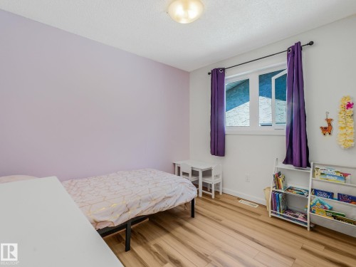 Light wood-finish flooring complements the room's color palette - 2035 49A Street, Edmonton, AB 