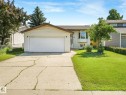 Exterior featuring a single-car garage, bay window, concrete driveway, and front lawn - 2035 49A Street, Edmonton, AB 