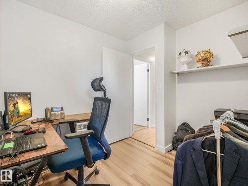 Light wood-finish flooring extending throughout the room - 2035 49A Street, Edmonton, AB 