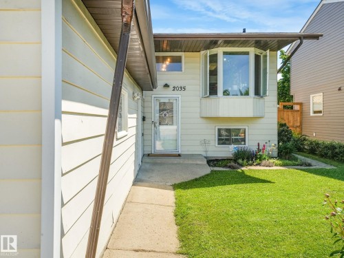 Cream-colored siding exterior featuring a prominent bay window with multiple panes - 2035 49A Street, Edmonton, AB 