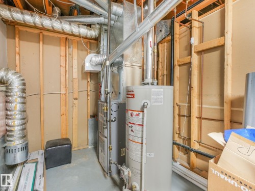 Utility area featuring a water heater, furnace, and exposed ductwork - 2035 49A Street, Edmonton, AB 