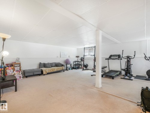 Expansive room featuring light-toned carpeting and a suspended ceiling - 2035 49A Street, Edmonton, AB 