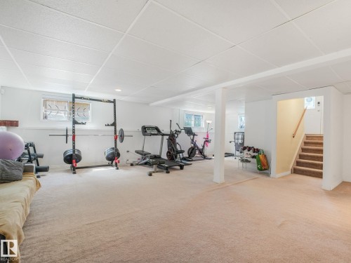Spacious lower level featuring light-toned carpeting and a grid ceiling - 2035 49A Street, Edmonton, AB 