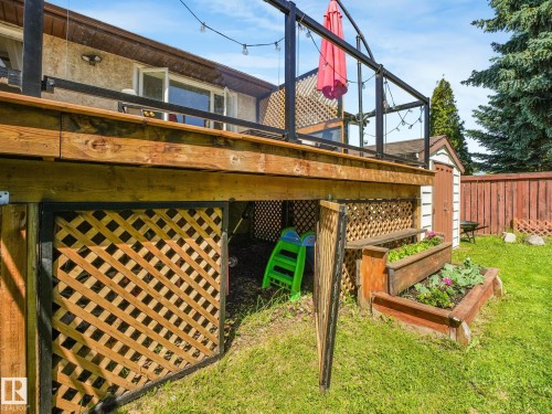 Elevated wood deck with black metal and glass railings - 2035 49A Street, Edmonton, AB 