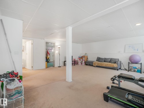 Spacious interior room with light-toned carpeting and a white drop ceiling - 2035 49A Street, Edmonton, AB 