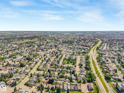 Expansive aerial perspective showcasing a residential neighborhood with tree-lined streets and established homes - 2035 49A Street, Edmonton, AB 