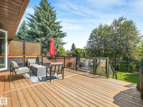 Expansive wood deck with glass panel railing - 2035 49A Street, Edmonton, AB 