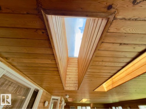 Vaulted wood-paneled ceiling featuring a large rectangular skylight - 134 Wolf Ridge Place, Edmonton, AB 