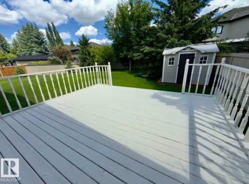 Expansive outdoor deck with white baluster railings - 134 Wolf Ridge Place, Edmonton, AB 