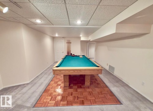 Recreational space featuring a pool table with teal felt, recessed lighting, track lighting, and a wood-finish parquet floor inlay - 134 Wolf Ridge Place, Edmonton, AB 