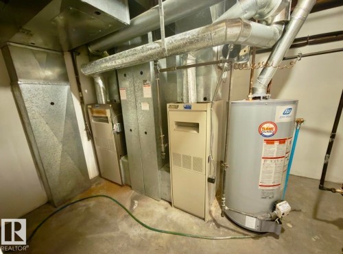 Essential utility area featuring a water heater, furnace system, and extensive ductwork - 134 Wolf Ridge Place, Edmonton, AB 