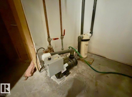 Water filtration system with associated plumbing, copper piping, and a concrete floor - 134 Wolf Ridge Place, Edmonton, AB 