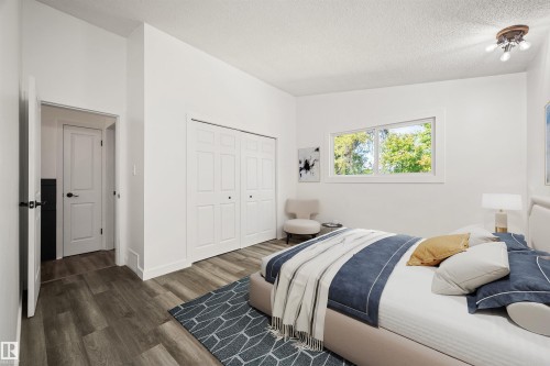 Spacious room featuring wood-finish flooring, white walls, and a large window - 28 Goodridge Drive, St. Albert, AB 