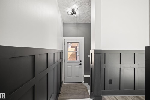 Entryway featuring dark wainscoting and light-toned walls - 28 Goodridge Drive, St. Albert, AB 