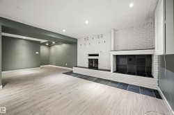 Finished lower-level space featuring light wood-finish flooring and recessed lighting - 