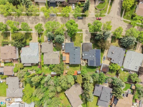 Aerial perspective showcasing residential properties with a variety of roof styles and mature tree coverage - 28 Goodridge Drive, St. Albert, AB 