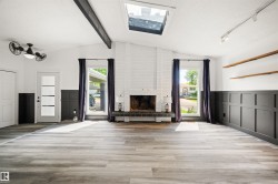 Vaulted ceiling featuring exposed beams and a skylight - 