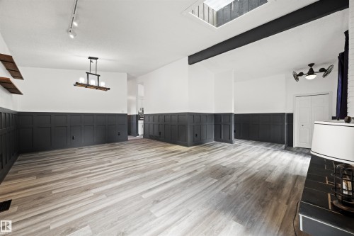 Spacious interior with wood-finish flooring, two-tone paneling, and an overhead skylight - 28 Goodridge Drive, St. Albert, AB 