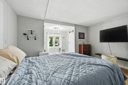 Bedroom with light gray walls and white trim - 