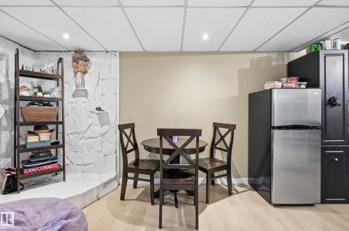 Recessed lighting illuminates a light wood-finish flooring - 12326 92 Street, Edmonton, AB - Indoor