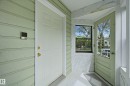 Entryway featuring light green siding, a white front door with brass hardware, and a storm door - 12326 92 Street, Edmonton, AB  -  Photo Showing Other Room 