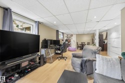 Open-concept space featuring light wood-finish flooring and recessed lighting - 