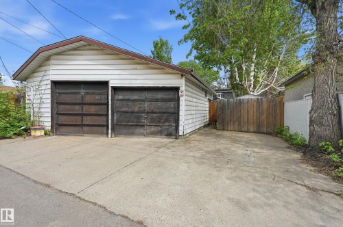 Detached two-car garage with concrete drive, white siding, and a brown trim roof line - 12326 92 Street, Edmonton, AB - Outdoor