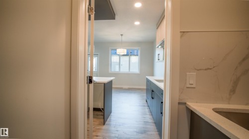 Modern kitchen area featuring recessed lighting and a contemporary pendant fixture - 44 Dalquist Bay, Leduc, AB 