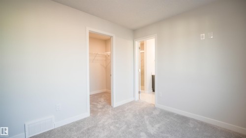 Carpeted interior space featuring light gray walls and white baseboards - 44 Dalquist Bay, Leduc, AB 