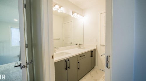 Double vanity featuring integrated sinks and chrome faucets - 44 Dalquist Bay, Leduc, AB 