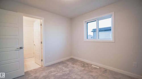 Bedroom featuring neutral-toned walls, gray carpet flooring, and white baseboards - 44 Dalquist Bay, Leduc, AB 