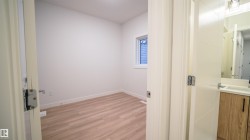 Bright room featuring wood-finish flooring and a single window with white trim - 