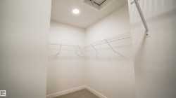 Walk-in closet featuring wire shelving, a hanging rod, recessed lighting, and carpet flooring - 