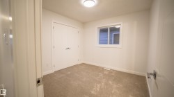 Carpeted room with a double-door closet, single window, white walls, and a flush mount ceiling light - 