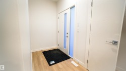 Entryway featuring light wood-finish flooring and white painted walls - 