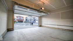 Spacious garage with concrete flooring and exposed drywall - 