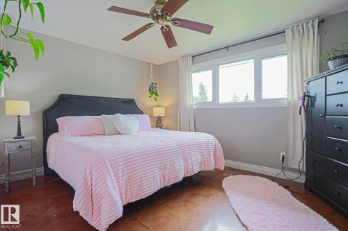 Hardwood-style flooring extends throughout this room, complemented by neutral wall paint and white trim - 2007 67 Street, Edmonton, AB 
