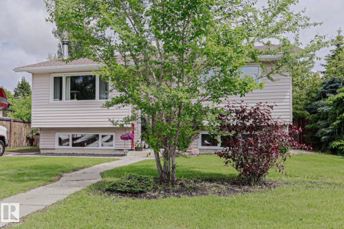 Split-level residence featuring light-colored horizontal siding and white trim - 2007 67 Street, Edmonton, AB 