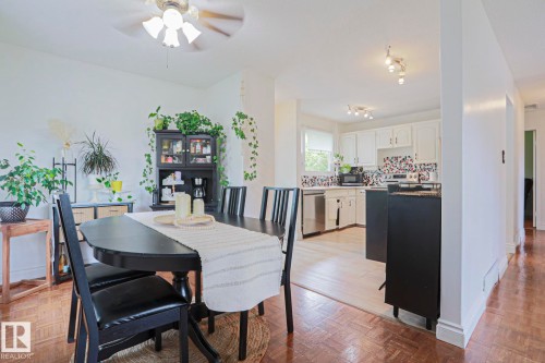 Spacious dining area featuring wood-finish flooring and a ceiling fan - 2007 67 Street, Edmonton, AB 