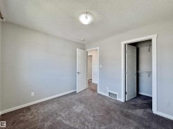 Spacious room with plush gray carpeting, light gray walls, and white trim - 