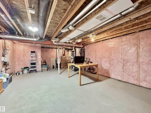 Unfinished basement featuring exposed joists and insulation-ready walls - 302 Balsam Link, Leduc, AB 