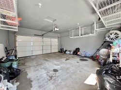 Attached two-car garage featuring a sectional overhead door with automatic opener - 