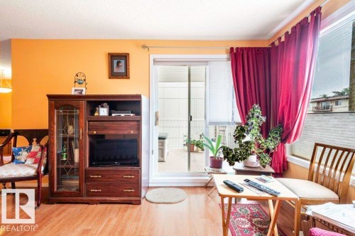 Living area featuring sliding glass patio doors leading to a covered deck for relaxing & entertaining. - 303 10528 77 Avenue, Edmonton, AB 