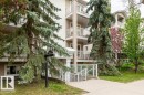 Multi-story residential building with vertical siding and multiple balconies featuring white railings - 303 10528 77 Avenue, Edmonton, AB 