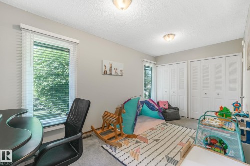 Room featuring neutral wall tones, textured ceiling, and two ceiling-mounted light fixtures - 17237 104 Street, Edmonton, AB 
