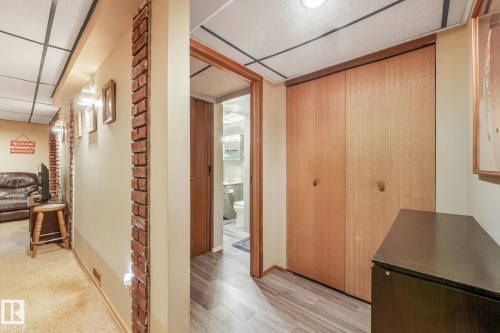 Hallway featuring brick accents, recessed lighting, and wood-finish flooring - 17237 104 Street, Edmonton, AB 