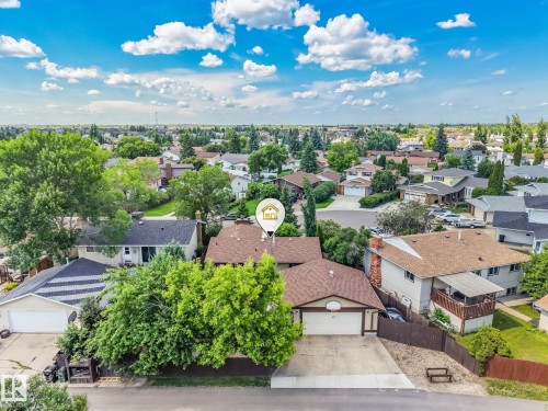 Aerial view of a residential neighborhood with detached homes, mature trees, and paved streets - 17237 104 Street, Edmonton, AB 
