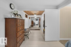 Recessed lighting illuminates the wood-finish ceiling, complementing the light wood-finish flooring - 